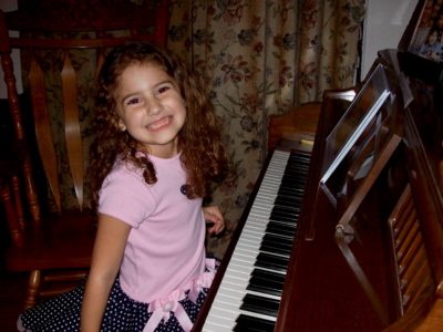 smiling girl at piano