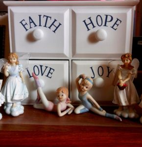 Four drawer chest with Faith, Hope, Love, Joy on each drawer and figurines in front of it