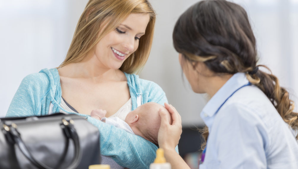 professional providing woman with newborn assistance with care
