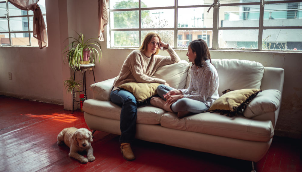 Mother and daughter at home having a serious talk.